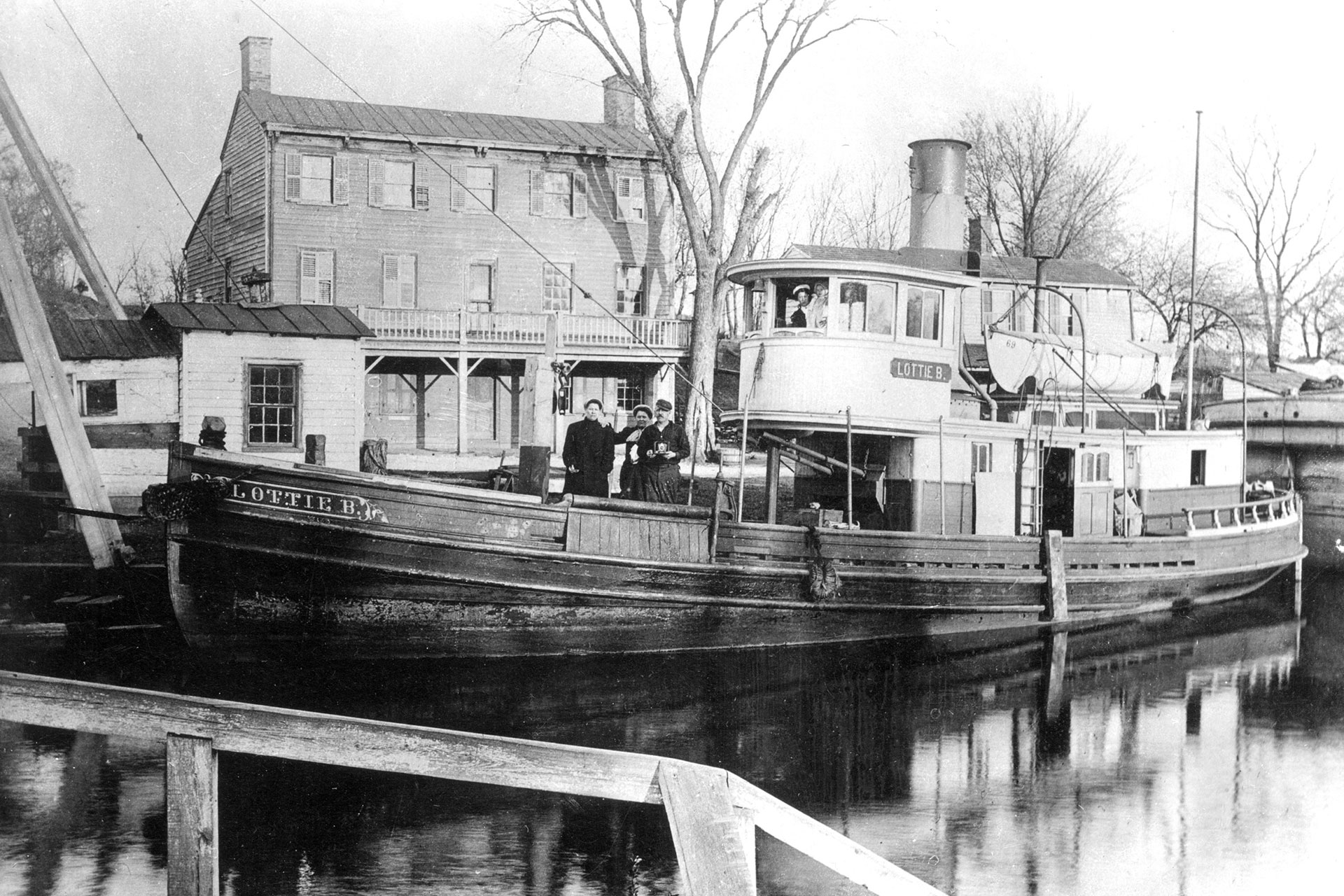 The steamboat Lottie B. sits in front of the Railroad Hotel at the Princeton Basin. As the name implies, the hotel served passengers from both canal and rail.