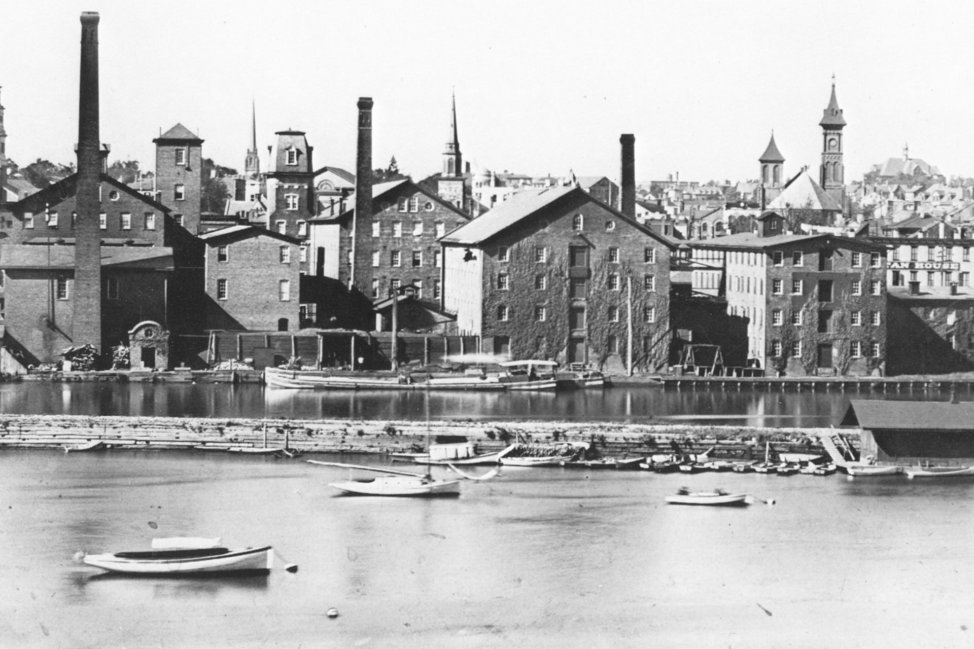 The New Brunswick factory district is shown on the D&R canal with the Raritan River in the foreground.