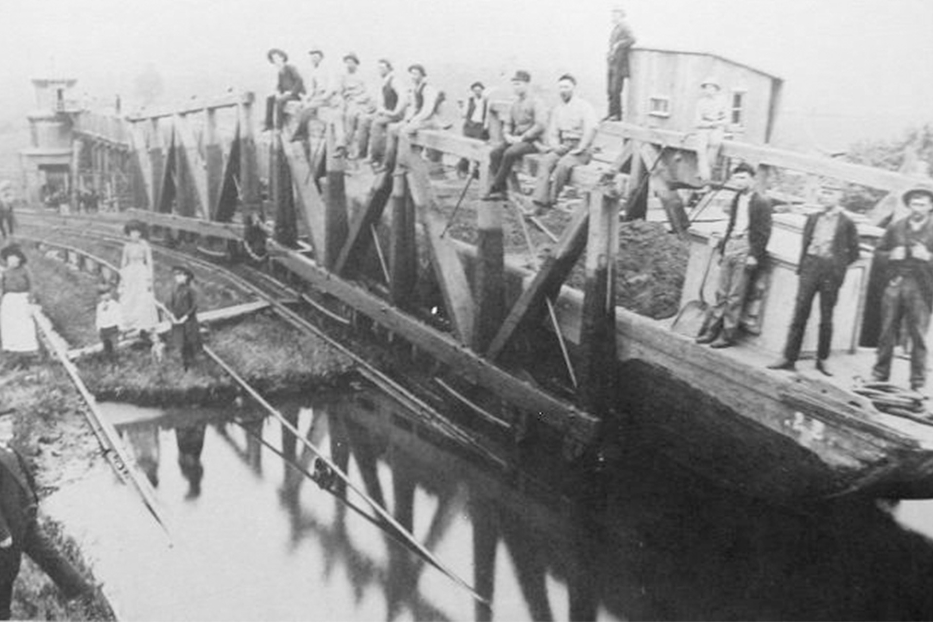 Workers pose on a works scow at the head of Plane 9 West.
