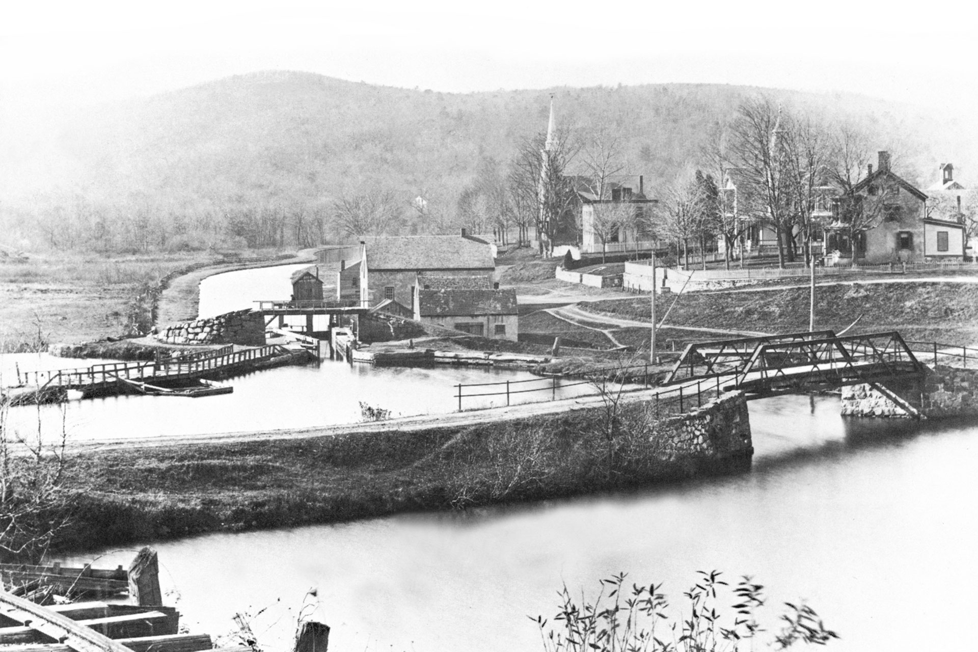 This view looks across the Musconetcong River toward Waterloo Village. The mule bridge is visible as is Lock 3 West, which brought the boats from the river back into the canal.