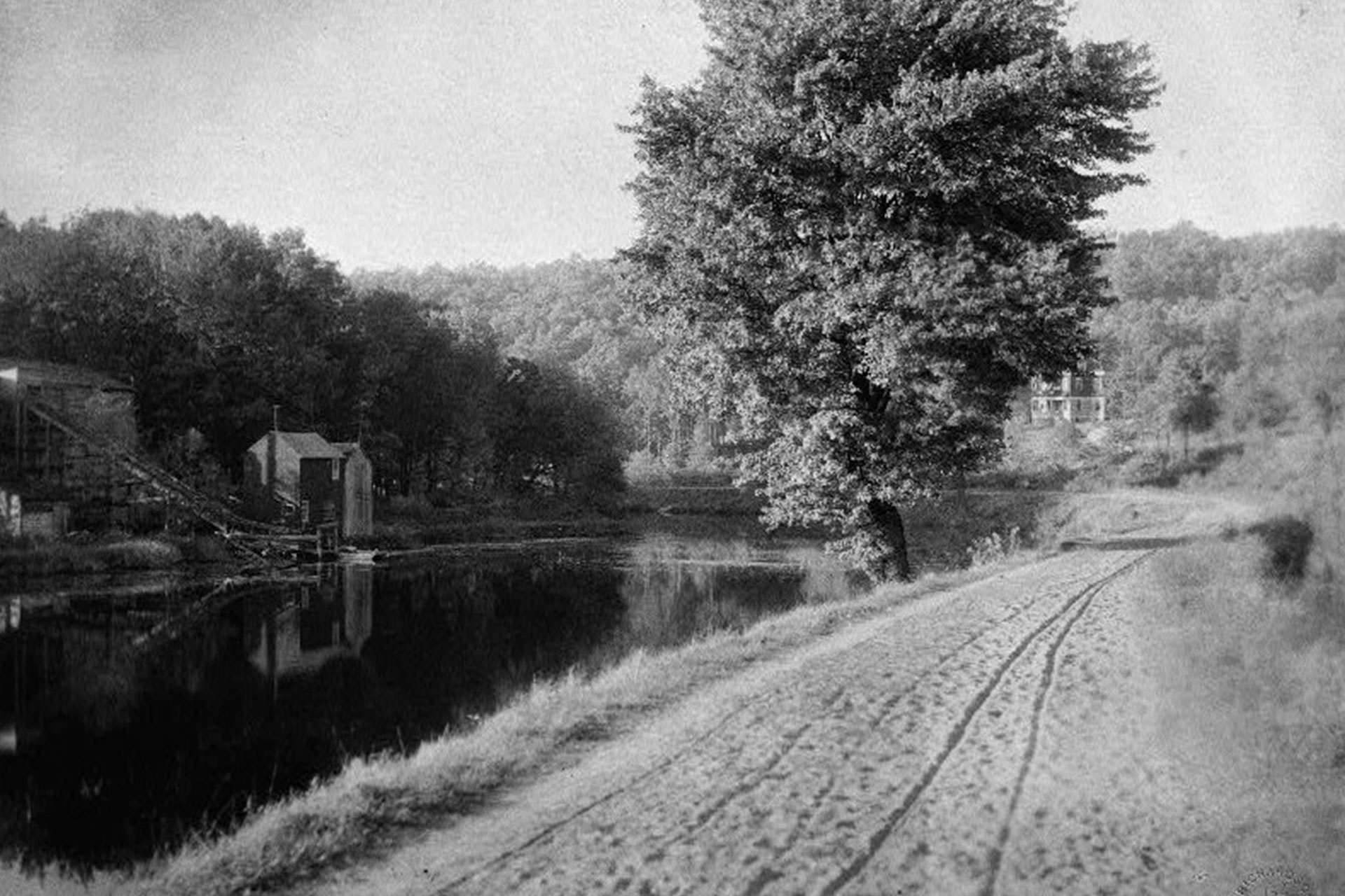 The canal, which is to the right of this view, approached Boonton in an area known as ‘Horshoe Bend’. The dammed portion of the Rockaway River served the ice industry, evidenced by the icehouse on the left.