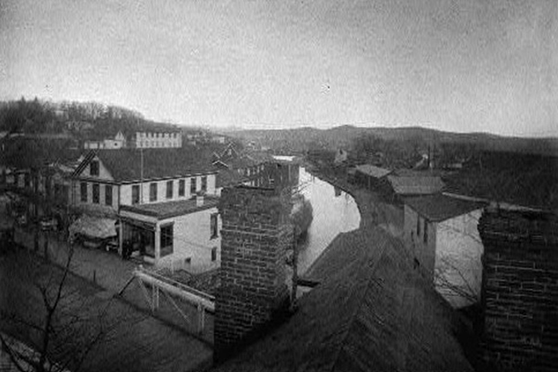 This photo was taken from the cupola of the Rockaway Hotel, and looks across Wall Street east along the canal. Today, this section of canal is municipal parking.