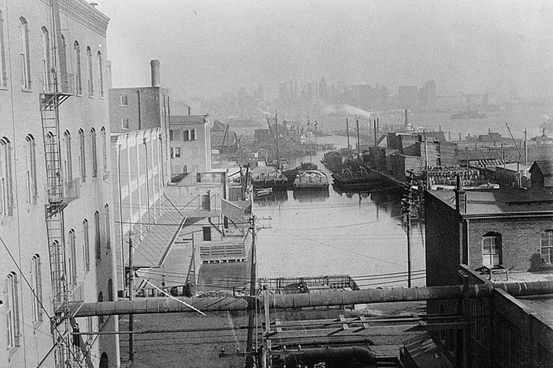 The Jersey City basin was the eastern terminus of the Morris Canal. The basin allowed access to the Hudson River, and NYC, whose skyline can be seen in the distance.